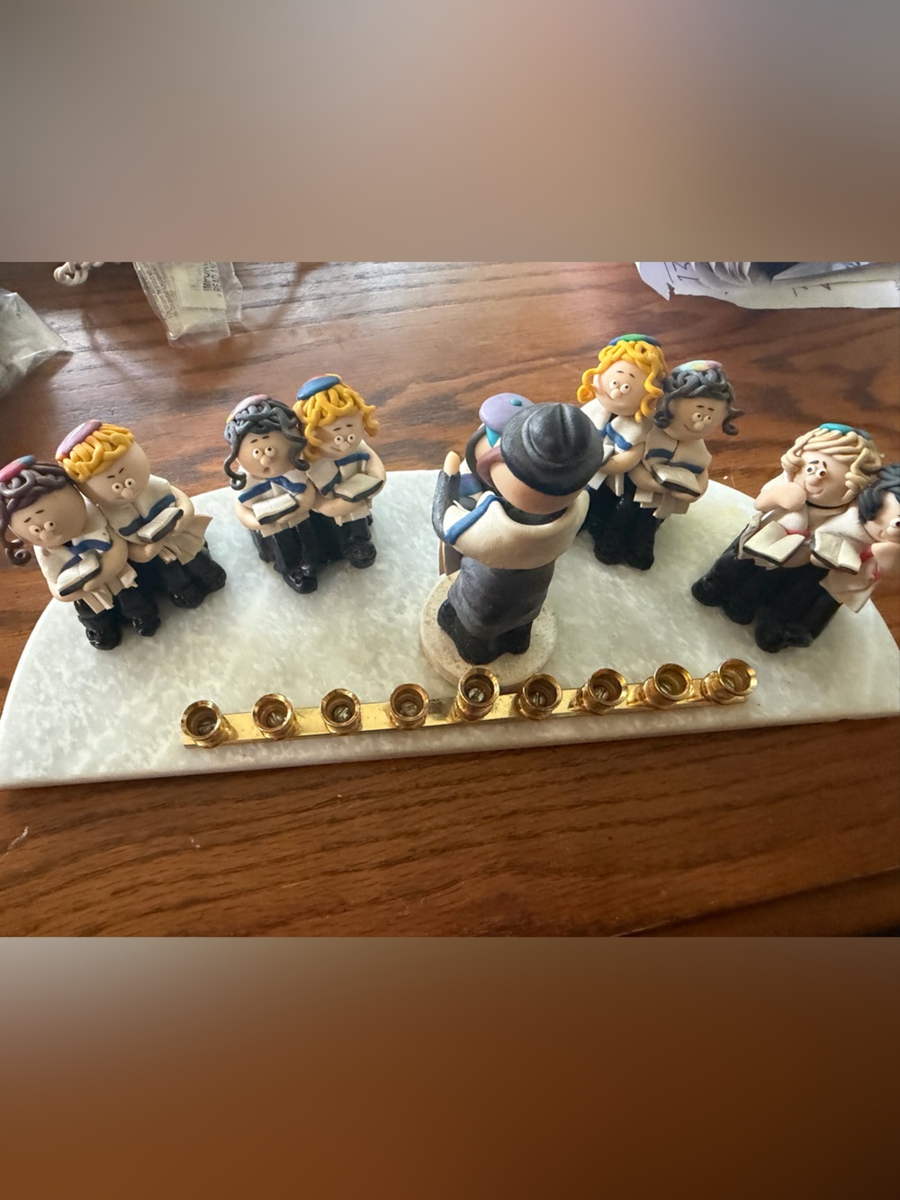 Festive Gold Menorah with White Marble Base and Multicolor Figurines